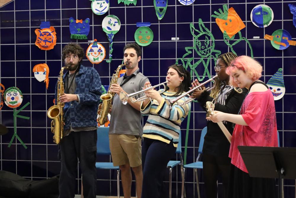 Wareham alumna Sophia Maniglia, center, performs with other students and music teacher Jason Roth, to her left. Photos by Nick Mossman
