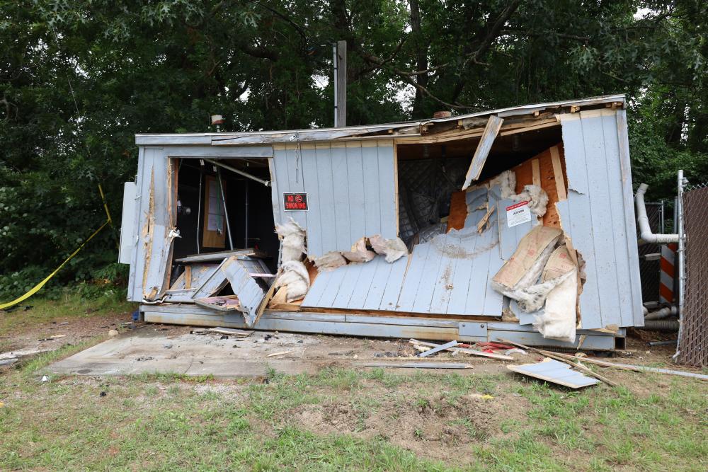 The front of a utility shed behind the 7-Eleven was caved in after a car slammed into it early morning on Monday, Aug. 3. Photos by Nick Mossman