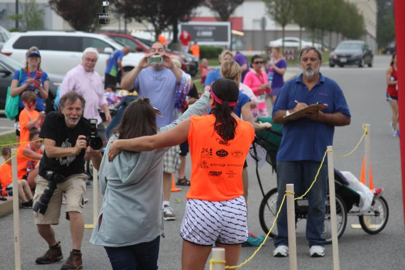 Racers cross the finish line during the 2017 Lazy Lobster road race. File photo