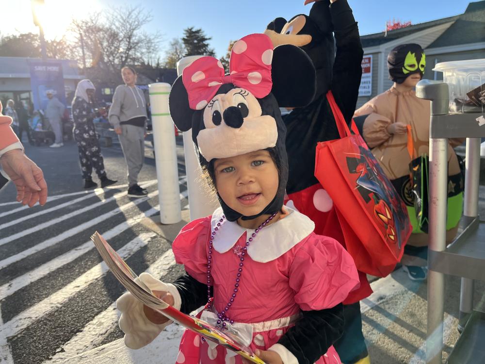 Stella Smith, 1, holds her new coloring book from Cumberland Farms during the trick or treat event on Friday, Oct. 30. Photos by Grace Roche
