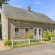 Front of the duplex at 17 Beeden Road in Westport, MA, with a white picket fence and double front doors