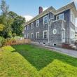 Side yard with lawn and a wooden fence beside 370 Maple Street, New Bedford, MA