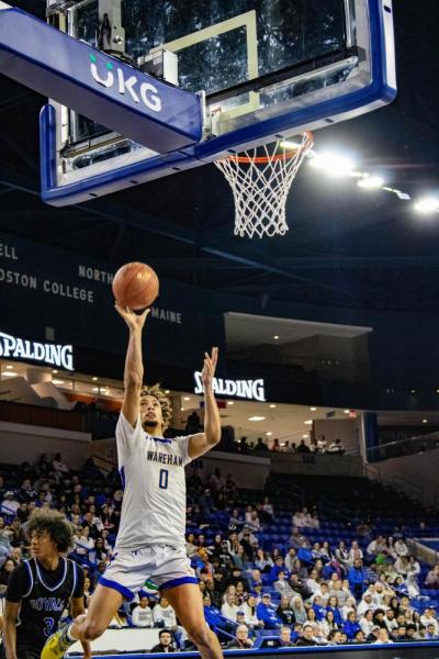 A rebound shot sees Amare Rose get air.