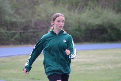 Dashing down the track, Ava Ostiguy practices sprinting.