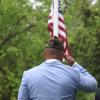 Onset VFW Post commander Benjamin Baptise salutes the flag.